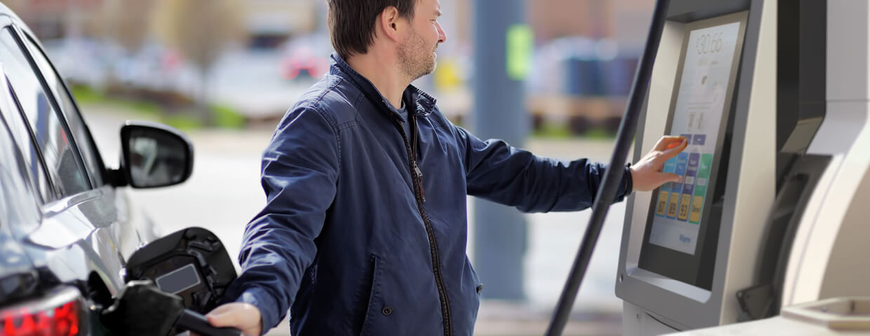 Man filling up car at gas pump