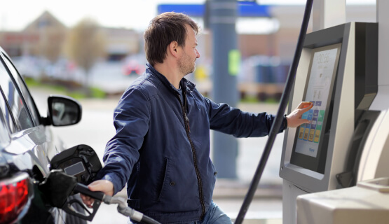 Man filling up car at gas pump