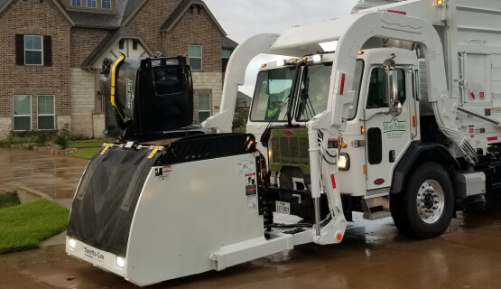 Engineered Products Garbage truck picking up curbside