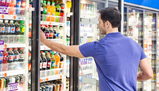 Refrigeration & Food Equipment Man choosing drink from cold case